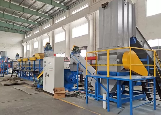Industrial machinery in warehouse with blue and yellow components for material handling and production.